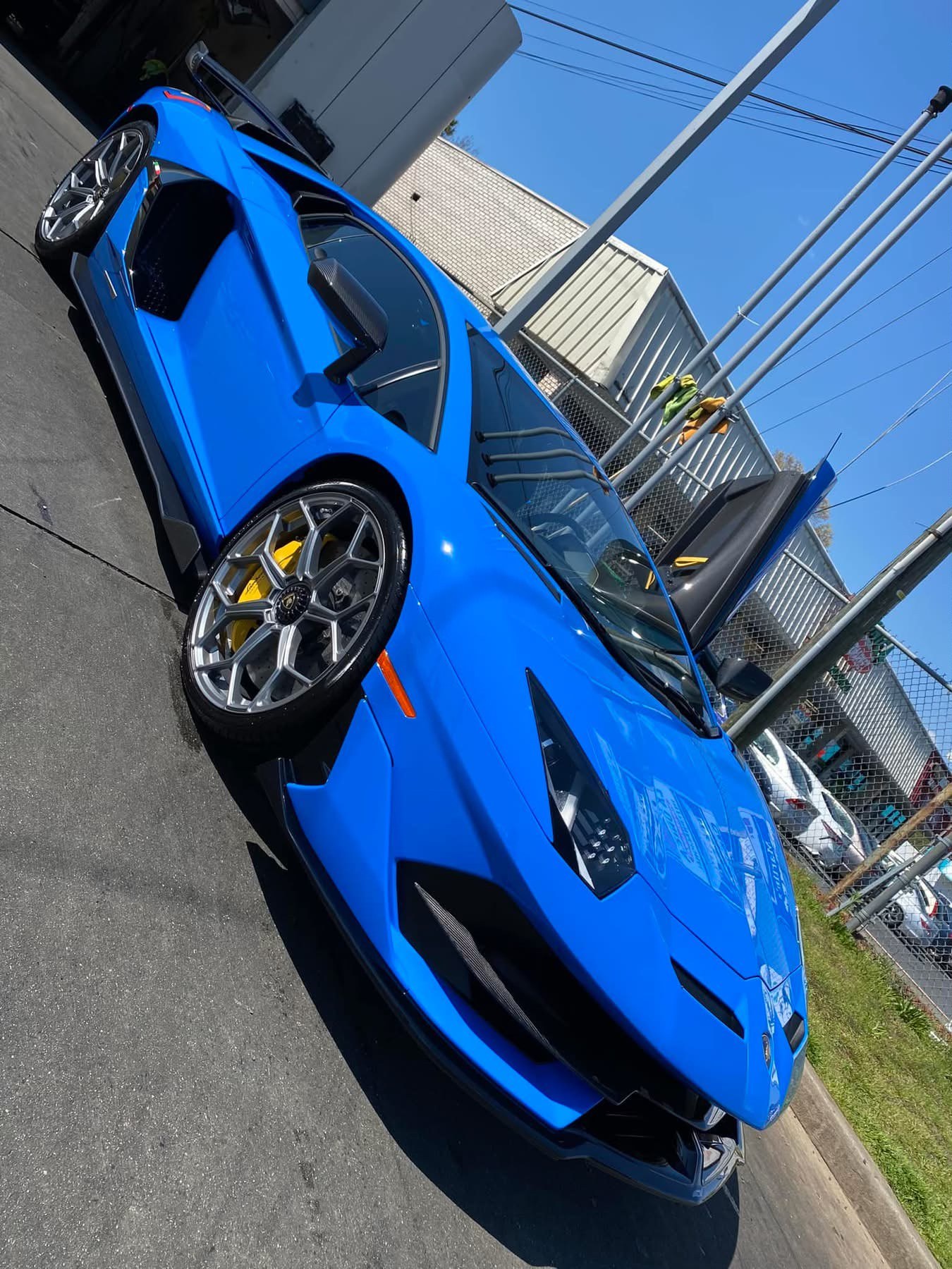 Freshly detailed blue Lamborghini gleaming in the sun